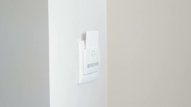 4k closeup video of female hand inserting electronic card key in hotel room