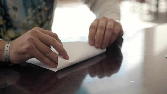 the loving couple makes the paper plane in hotel