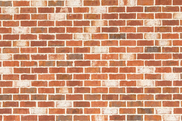 Brick wall with orange, brown and white bricks.