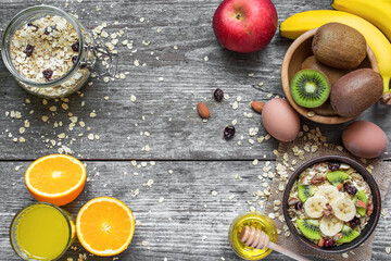 healthy breakfast with oats, fruits, berries, egg, honey and orange juice