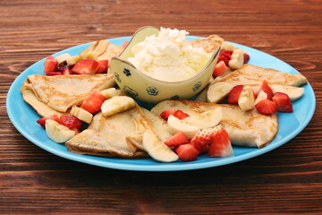 Delicious pancake with sliced of strawberry and banana