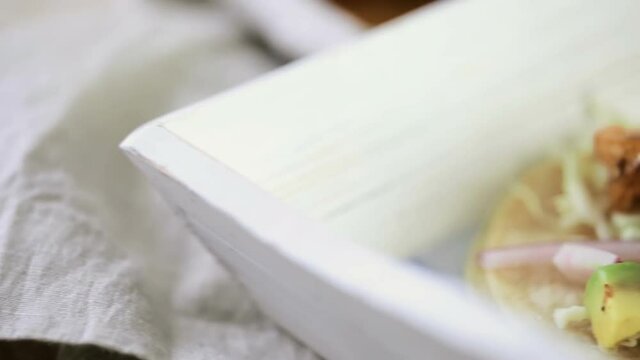 Fresh chipotle shrimp tacos with cotija cheese on a white corn tortillas