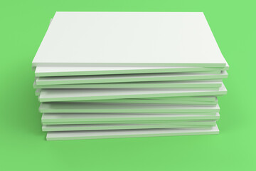 Stack of blank white closed brochure mock-up on green background