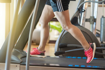 Fototapeta na wymiar woman on a treadmill at the gym