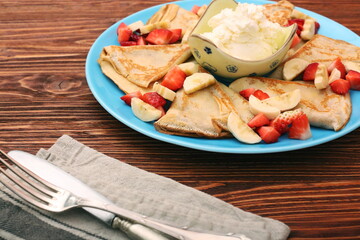 Delicious pancake with sliced of strawberry and banana