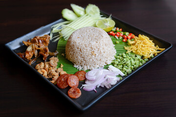 Thai food - Rice mixed with shrimp paste (Kao Cluk Ka Pi) with side dish as a mango, lemon, chili, cucumber, scrambled egg, cow-pea, shallots, Chinese sausage, dried shrimp and pork - obrazy, fototapety, plakaty