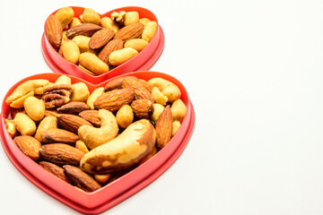 isolated double hearts filled with mixed nuts