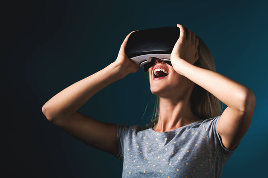 Young woman using virtual reality headset - Powered by Adobe