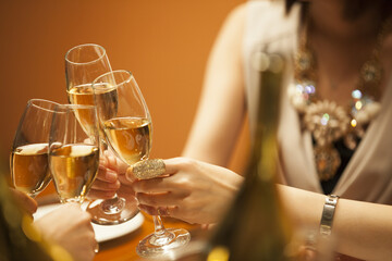 The women are drinking with a champagne at a luxurious restaurant