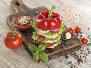 Vegetarian sandwich with vegetables on a wooden board. 