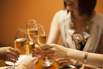 The women are drinking with a champagne at a luxurious restaurant