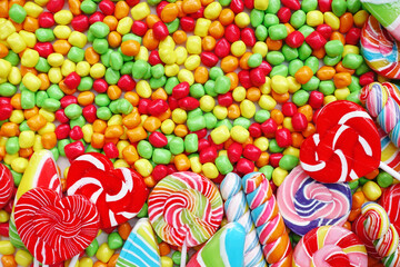 Fototapeta na wymiar sweets and sugar candies colorful, handmade swirl lollipop for background