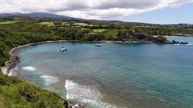 This is an aerial video of Honolua bay on Maui, Hawaii. This is a favorite bay for snorkeling, diving, and surfing.