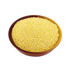 Dry millet in a bowl isolated on white. Spilled millet.