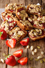 Granola bars with strawberry jam, seeds and nuts close-up. vertical