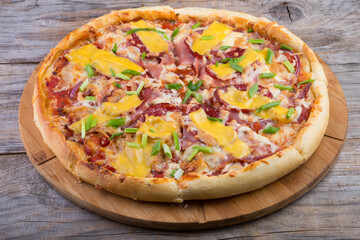 Whole pizza on a wooden tray