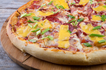 Whole pizza on a wooden tray
