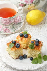 Homemade pie for tea from coconut, lemon and fresh berries blueberries.Rustic style. Selective focus