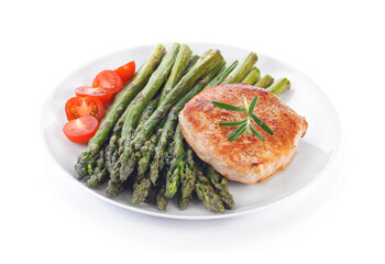 Cooked asparagus with meat steak and tomatoes on a white plate