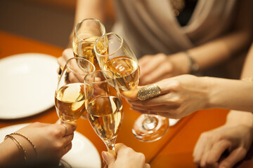 Women are toasting with champagne glasses