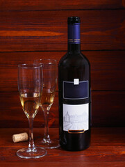 Still life with a bottle of wine and flowers