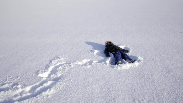 Iceland scenic landscape nature winter snow cold outside kid snow angel