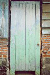 The old blue wood door is decaying