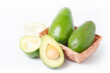 Avocado fruit and oil in a basket on white background,Healthy food