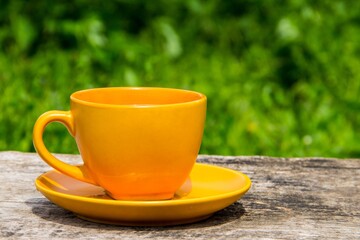 Coffee cup on rustic wooden table outdoor