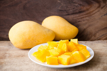 Sliced mango fruit on white dish ready to eating