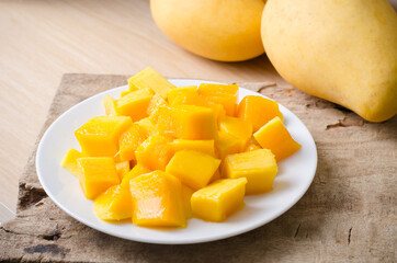 Sliced mango fruit on white dish ready to eating