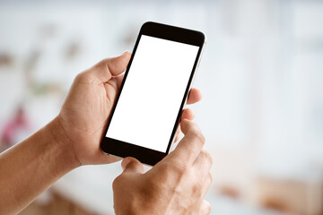 Man holding smart phone with blurred backgroung. Blank screen for Graphic display montage.