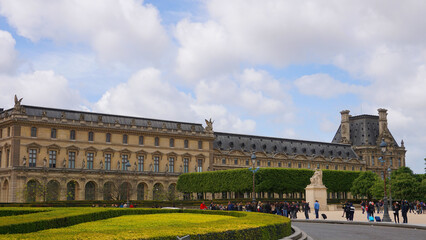 Photo of iconic Louvre Palace on a cloudy spring morning, Paris, France