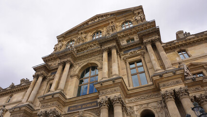Obraz premium Photo of iconic Louvre Palace on a cloudy spring morning, Paris, France