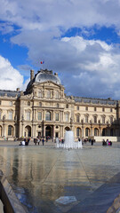 Fototapeta na wymiar Photo of iconic Louvre Palace on a cloudy spring morning, Paris, France