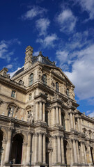 Fototapeta na wymiar Photo of iconic Louvre Palace on a cloudy spring morning, Paris, France