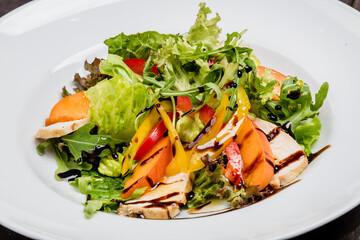 Spring salad with greens, peach and chicken