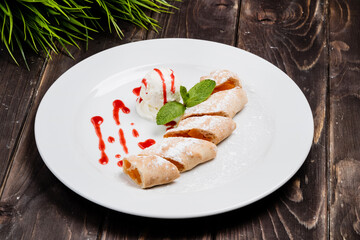 Strudel with peach ice cream and sauce