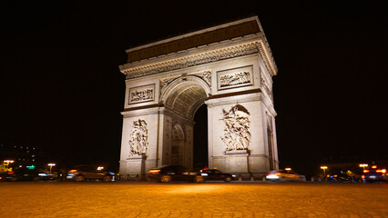 Night photo of iconic Arc de Triomphe in Champs Elysees, Paris, France