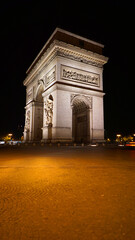 Night photo of iconic Arc de Triomphe in Champs Elysees, Paris, France