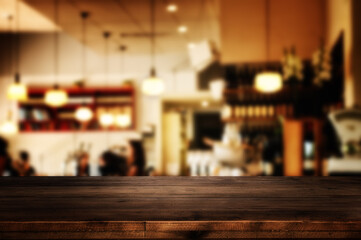 wooden table in front of abstract blurred restaurant lights