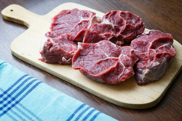 Fresh raw beef on wooden cutting plate