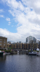 Obraz premium Photo of Saint Katharine's docks near Tower Bridge on a cloudy spring morning, London, United Kingdom