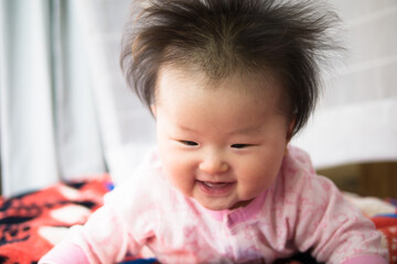 Baby playing at the window side curtain race / Six months after birth