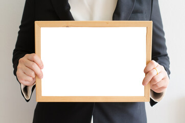 business woman holding  brown board in her hands.