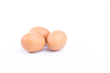 Three fresh hen eggs isolated white background.