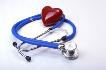 Red heart and a stethoscope isolated on white background.