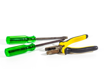 screwdriver and  pliers on white background