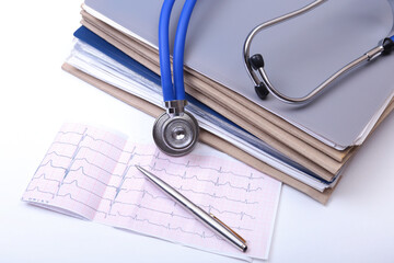 Closeup Folder file, stethoscope on a rx prescription, red heart and phone isolated on white background.
