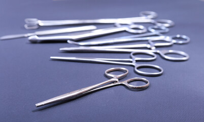 Close Up Surgical instruments and tools on grey mirror background. Selective focus.